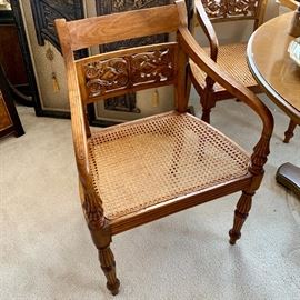 Set of six wooden carved dining chairs with cane seat