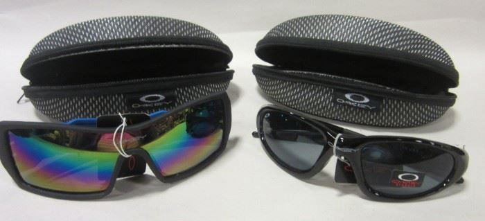 TWO PAIRS OF OKLEY SUNGLASSES WITH CASES