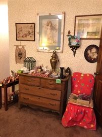 antique dresser, upholstered chair, framed prints