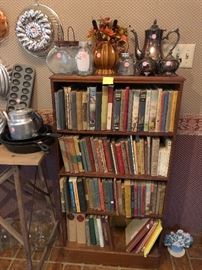 cast iron skillets, silverplate tea set, vintage school books, bookcase