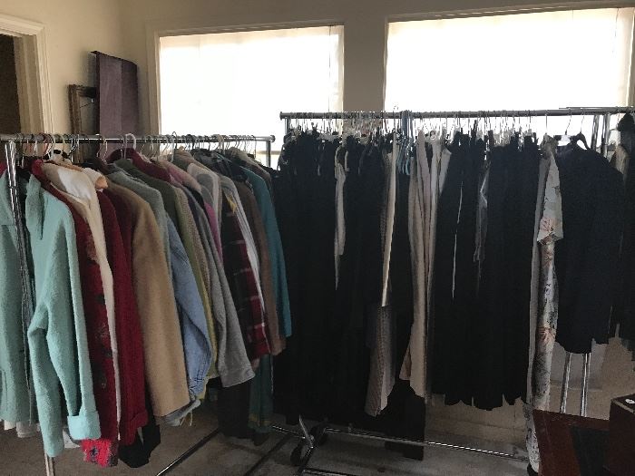 Six dress racks and 4 tables full of clothing.  This is the $10.00 each piece room. With clothing by Eileen Fisher, Calvin Klien and Anne Klien, sweaters, pants, jackets .....