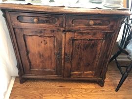 Antique Cherry 2 drawer cupboard, 19" deep on top at the widest point, 34.5" tall. 40" wide. 
