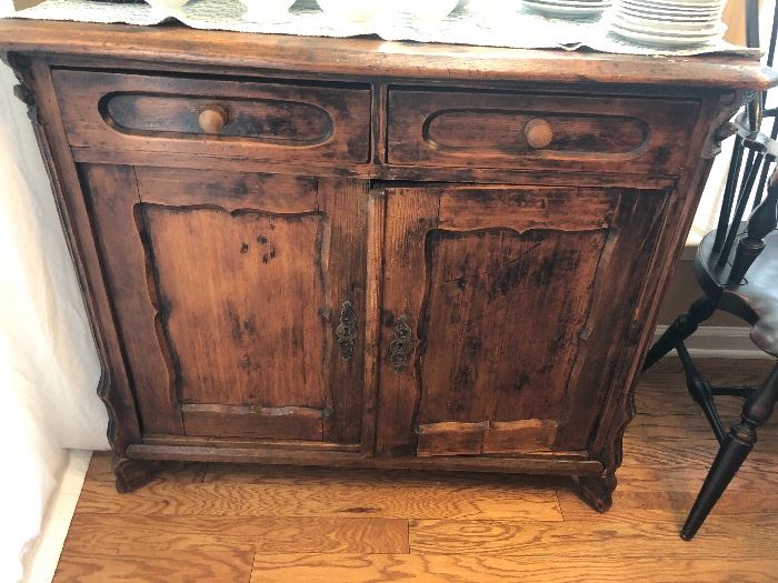 Antique Cherry 2 drawer cupboard, 19" deep on top at the widest point, 34.5" tall. 40" wide. 