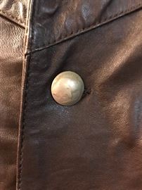 Buffalo head buttons on leather vest