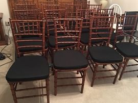 Several Bamboo Reception Chairs with Black Cushions