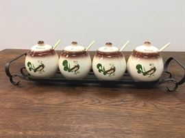 Four Piece Ceramic Condiment Set With Rooster Design and Black Metal Stand
