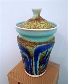 Lot 212: G. Bunker Lidded Vase Porcelain Studio Pottery 1970's.
6" H x 4" W lidded vessel numbered "P-23" from the 1970's. Lovely glaze and exceptional piece of art studio pottery. Signed by artist. No chips or kiln flaws. These pieces do not come up for auction often. Living estate of Charles Rathbun.