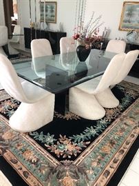 Interior Modern clean dining on a beveled tinted glass table from the merchandise mart with 3 panel support,96"L x 44"W  seats 6 to 8 comfortably 6 modernist Upholstered chairs attributed to Verner Panton just need a touch of cleaning to be ready for your home.