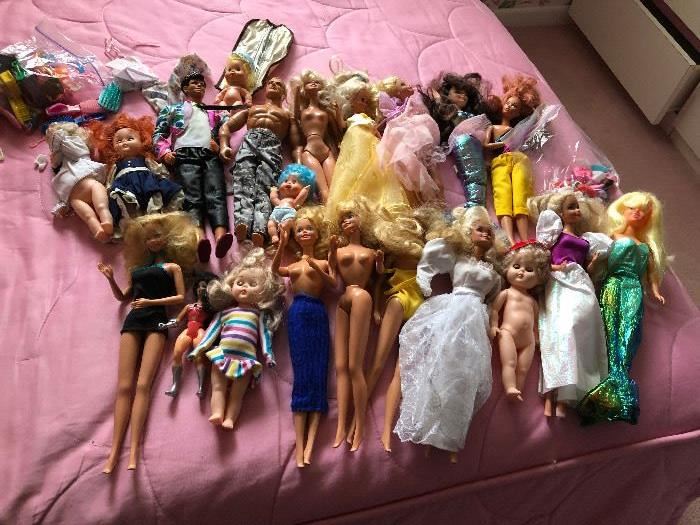 Barbie dolls, clothes and 2 cases