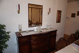 Buffet, mirror, crystal ice bucket, milk glass candy dish, wall sconces and ficus tree