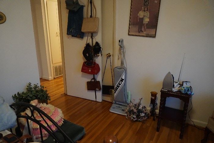 Oreck vacuum, purses, side table, iron, weather radio