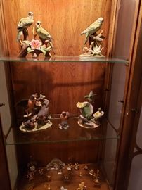 Ceramic birds, lighted curio cabinet