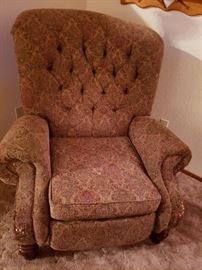 Tan armchair with floral design.