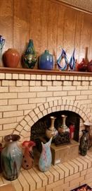 Lots of colorful vintage glass vases, some are large