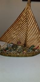 A bedazzled boat for the woman who loves glitter, made with vintage costume jewlery