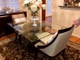 Glass top dining table with scrolled iron base & two chairs 