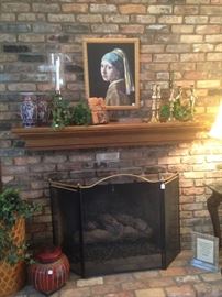 Brass candle holders, fireplace screen, and other hearth decor