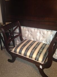 Formal bench with padded fabric seat and raised sides