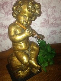 Flute playing cherub statue
