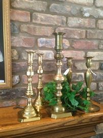 Variety of sizes and styles of brass candle sticks