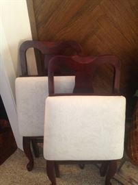 Two padded seat folding chairs