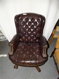 brown leather office chair on wheels