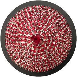 Faux ruby belt buckle; about 4” with no black banding— shot on black background which explains black edge