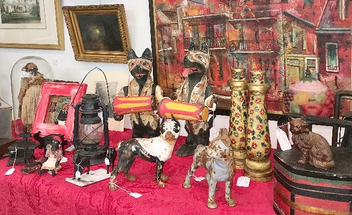 Outsider art and Black Americana include two carved wolf or dog drummers from a North Carolina vendor; antique Hubley dogs and horses; handmade cloth dolls: a folk art handled bandbox-style lidded box; brightly painted vintage folk art candle holders and folk art baskets and carved figures.