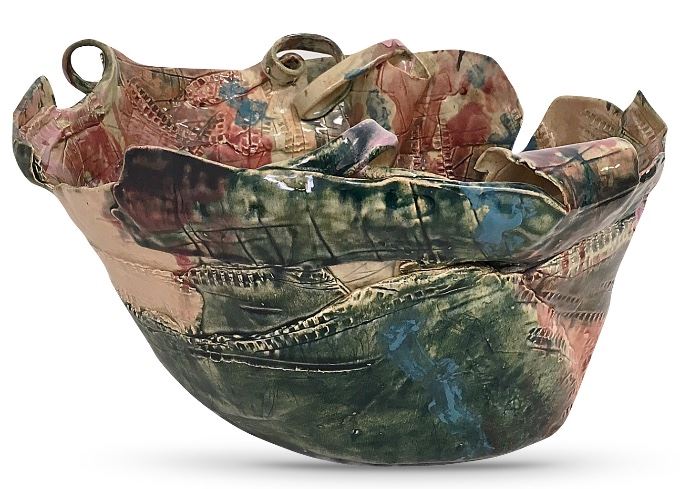 An amish ceramic art bowl, about 14” at the widest and 8” tall; gallery label indicates the colors evoke quiet reflection and the shape recalls the free movements of nature