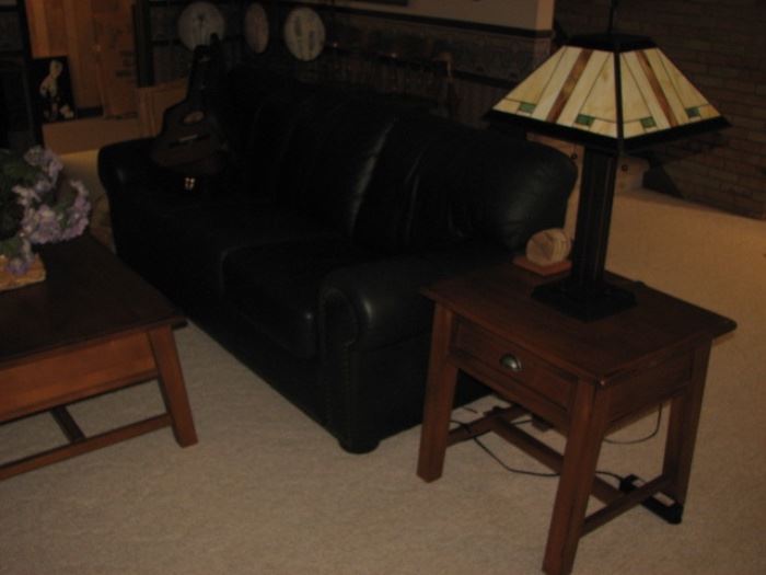 Green leather sofa with brass nailheads