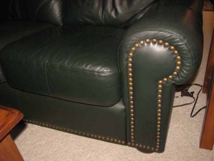 Green leather sofa with brass nailheads
