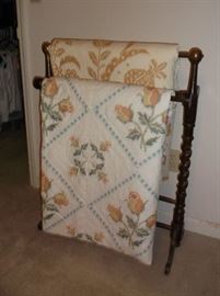 Quilt rack and two cross stitched quilts