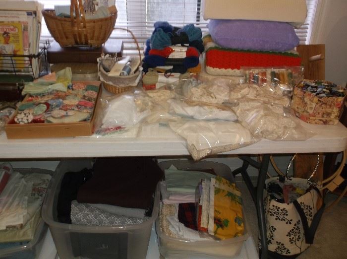 Sewing supplies, lace, fabric pieces, and yarn
