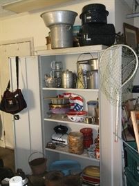 Two door metal cabinet and large cooking pots