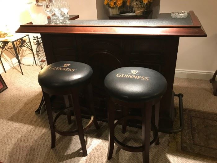 GUINNESS BAR AND PAIR OF BAR STOOLS IN DISTRESSED WALNUT. 