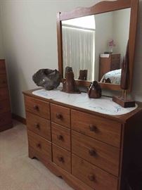 Mid-century antique dresser with mirror. Assorted pieces of hand thrown pottery and wooden sculptures.