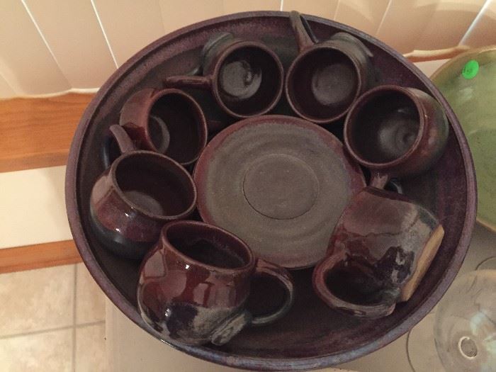 Matching large hand thrown pottery bowl with cups and saucers