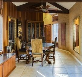 Buffet and pedestal table with 4 chairs. Custom  1970's cabinet made by wood worker John Glock. Large Gilt mirrors.