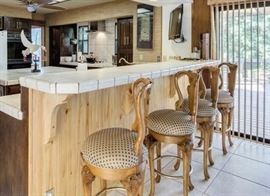 Four English pear wood carved bar stools.