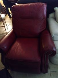 Still with tags there are 3 red leather  recliners