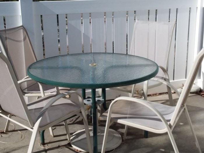 Classic glass top patio table and four chairs.