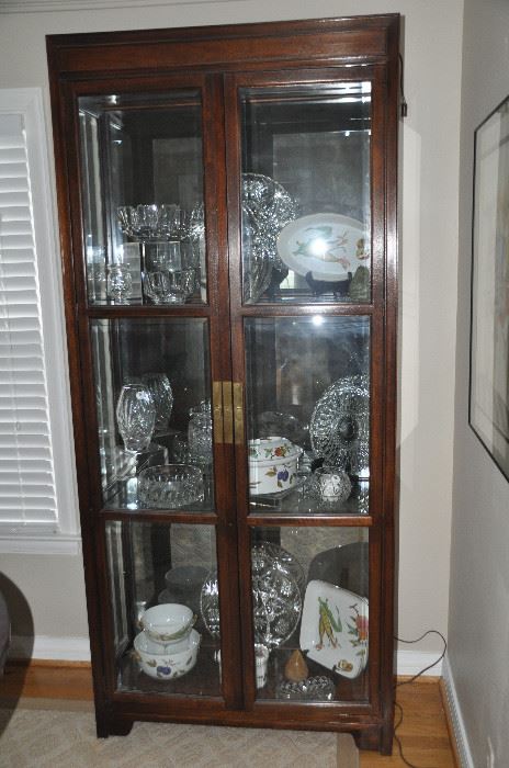 Wonderful mahogany with antique brass hardware lighted Curio Cabinet with two glass shelves and smoked mirrored back.  36”w x 81”h x 16”d 