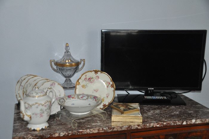 Wonderful antique china pieces including a 6 piece set of Theodor Haviland Limoges dessert plates, a Baronet China bowl made in Germany, A Haviland and Co.  Tea Pot and a gorgeous Limoges gold serving plate. Also shown is a Samsung 28” TV