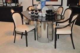 Custom made double cylinder chrome pedestal Dining Table with 3/4" granite top with 6 vintage black lacquer and ivory leather dining chairs by Stendig Co.
