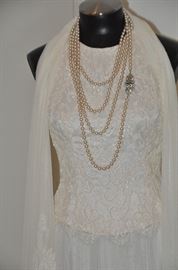 Fantastic 116” knotted pearls with vintage art decoclasp, shown as 4-strands on the Carmen Marc Valvo ensemble. 