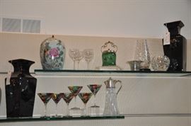 Wonderful pair of black ceramic glazed vases with foo dogs shown with a pair of ceramic “flamingo” Ginger Jars with wooden lids, an antique Royal Doulton painted jar with lid and more crystal vases. 