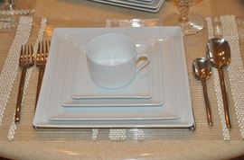 One of the nine 5 piece place settings available of Zen Apilco, made in France dinnerware shown with one of a 12 five piece place settings of Mikasa stainless flatware 