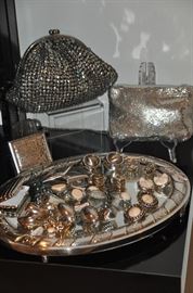 Terrific beaded vintage evening handbags shown with a great selection of sterling and silver clip earrings shown on a heavy silver mirrored tray 