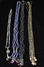 Beautiful necklaces by Sharon Meyer:
Moonstone necklace with silver, iolite lariat with rubies, Grey freshwater pearls with pink tourmaline 3-strand lariat and 4-strand lariat with jade and freshwater pearls