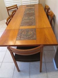 Dining Room Table/6-Chairs with 2-18" Drop-Side Leaves. This Stunning Danish Modern-Style Set is by "Skovby". The Center Tile Inset Design is in Rich Dark Tones. Size 61" X 38"